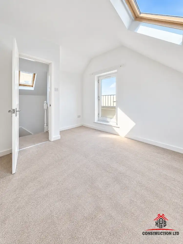 Finished loft conversion bedroom with rooflight and Juliet balcony